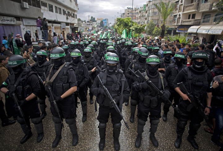 Masked Hamas gunmen display weapons during a rally to commemorate the 27th anniversary of the Hamas militant group, in Gaza City, Dec. 2014.