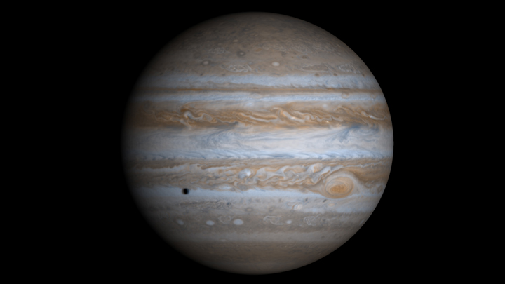 Jupiter, with the shadow of Europa across the clouds.