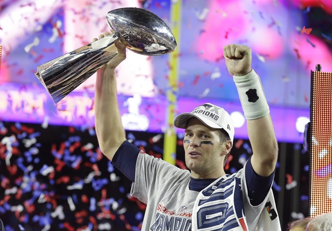 New England Patriots quarterback Tom Brady celebrates with the Vince Lombardi Trophy after the NFL Super Bowl XLIX football game against the Seattle Seahawks Sunday, Feb. 1, 2015, in Glendale, Ariz. The Patriots won 28-24. 