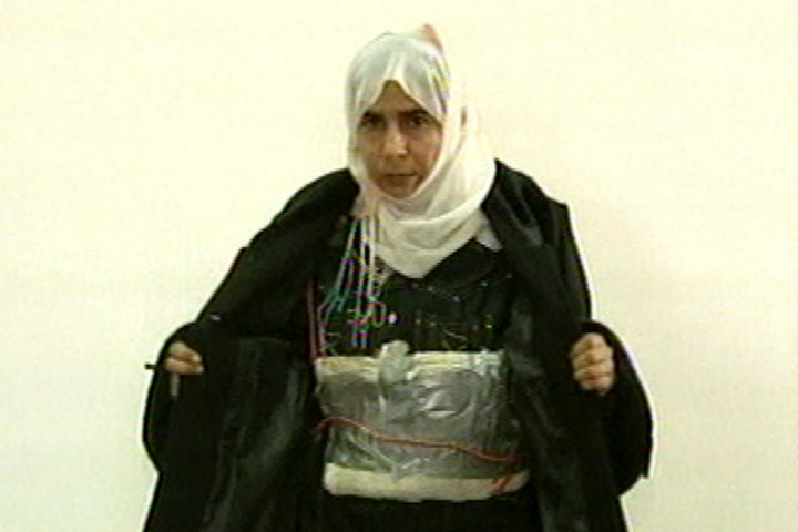 In this file image made from television on Nov. 13, 2005, Iraqi Sajida al-Rishawi opens her jacket and shows an explosive belt as she confesses on Jordanian state-run television to her failed bid to set off an explosives belt inside one of the three Amman hotels targeted by al Qaeda.
