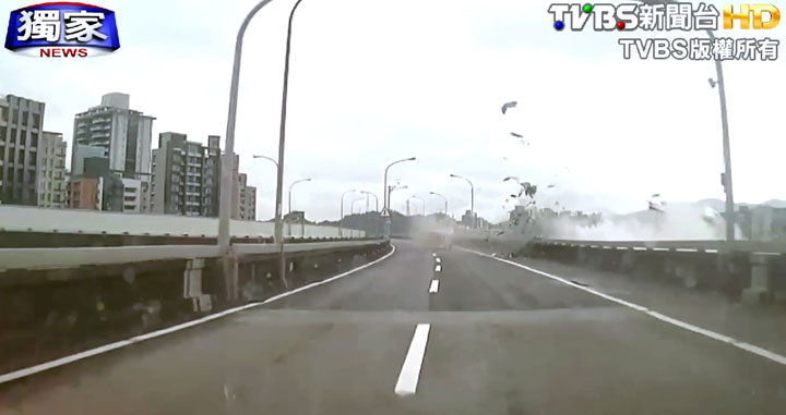 This image taken from video provided by TVBS shows an elevated roadway just after a commercial airplane clipped it and careened into a river in Taipei, Taiwan, Wednesday, Feb. 4, 2015.