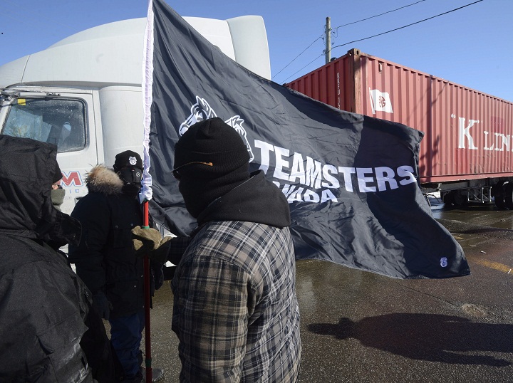 Canadian Pacific Railway workers walk the picket line while on strike at the Cote Saint-Luc railyard in Montreal on Monday, Feb. 16, 2015.