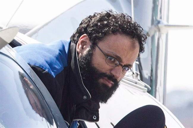 Chiheb Esseghaier, one of two men accused of plotting a terror attack on rail target, is led off a plane by an RCMP officer at Buttonville Airport just north of Toronto on Tuesday April 23, 2013.