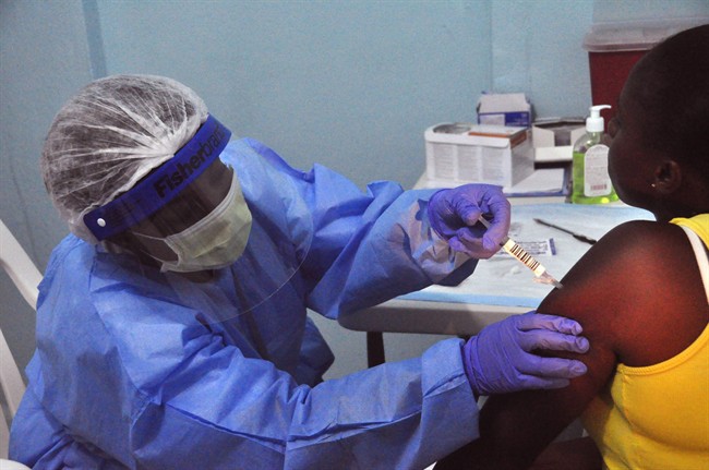 A woman is injected by a health care worker as she takes part in a Ebola virus vaccine trial at the Redemption hospital in Monrovia, Liberia, Feb.2, 2015.