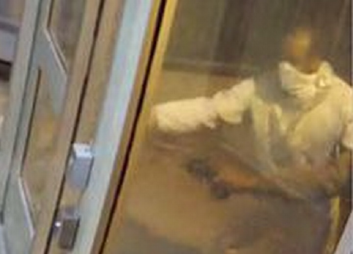 Security camera image of Suspect #2 and arm of Suspect #1.