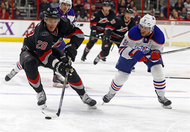 Carolina Hurricanes' Alexander Semin (28), of Russia, works the puck on Edmonton Oilers' Derek Roy (8) during the second period of an NHL hockey game in Raleigh, N.C., Sunday, March 8, 2015, in Raleigh, N.C.