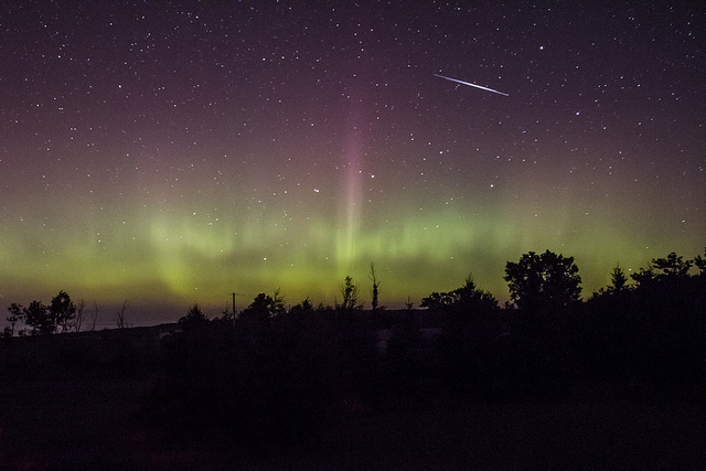 A pair of satellites cross the northern lights over southern Ontario.