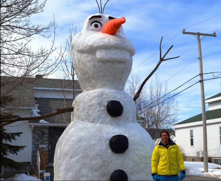 Benoît Sabourin stands in front of his 20-foot snow sculpture of Olaf in Saint-Jean-Sur-Richelieu, Que. on March 23, 2015.