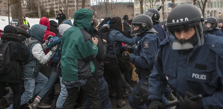 Protesters and police scuffle during a protest against austerity organized by the ASSE student group in Quebec City, Thursday, March 26, 2015.