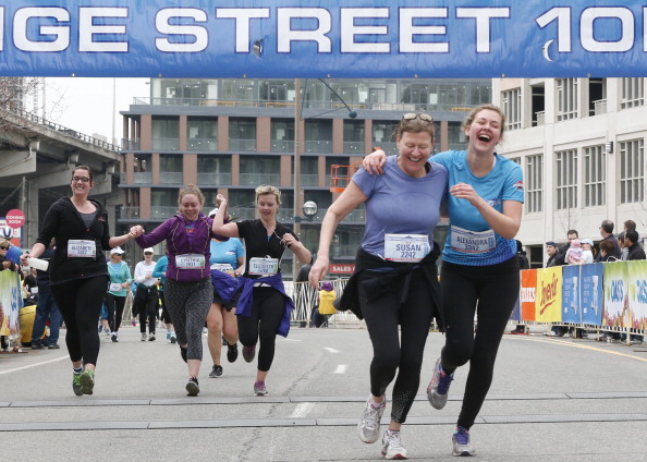 Alexandra McRobert and her mother Susan Humphrey cross the finish line of the Yonge Street 10k run at Fort York Blvd Sunday morning. Toronto, April 13, 2014.  