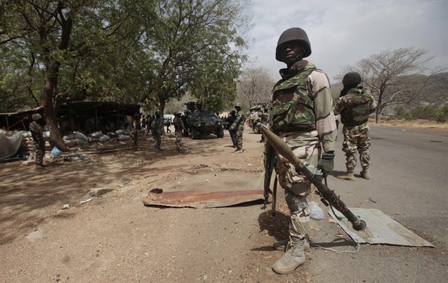 FILE - In this file photo taken Wednesday, April 8, 2015, Nigerian Soldiers man a check point in Gwoza, Nigeria, a town newly liberated from Boko Haram.