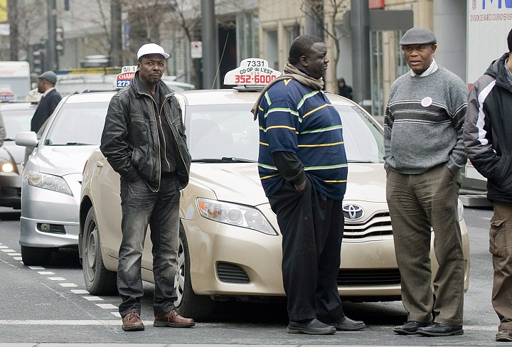 Taxi drivers block a street outside the Montreal courthouse, Wednesday, May 2, 2012, to show their support for Guercy Edmond who is in custody on charges of aggravated assault, assault with a weapon, hit-and-run and dangerous driving.