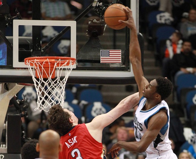 Minnesota Timberwolves’ Andrew Wiggins (22) dunks on New Orleans Pelicans’ Omer Asik in the half of an NBA basketball game Monday, April 13, 2015, in Minneapolis.