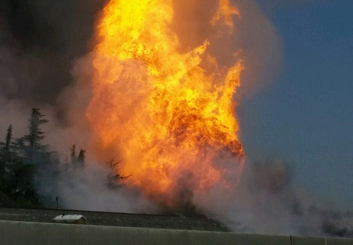 A fireball erupts after a large gas pipeline exploded in Fresno, Calif., Friday, April 17, 2015. The explosion and fire closed both directions of Highway 99, authorities said.