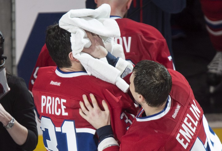 Montreal Canadiens goalie Carey Price gets pied by teammate Alexei Emelin following their 4-3 victory over the Detroit Red Wings during overtime in NHL hockey action Thursday, April 9, 2015 in Montreal. Price broke a team record with 43 wins for a goaltender.