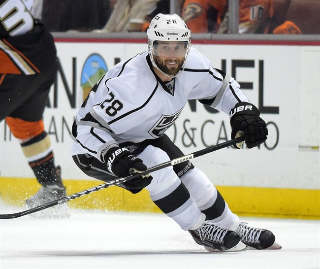 FILE - Los Angeles Kings center Jarret Stoll skates with the puck during the first period in Game 2 of an NHL hockey second-round Stanley Cup playoff series Anaheim Ducks, in this May 5, 2014 file photo taken in Anaheim, Calif. Stoll has signed with the New York Rangers after pleading guilty to two reduced charges in felony cocaine case.