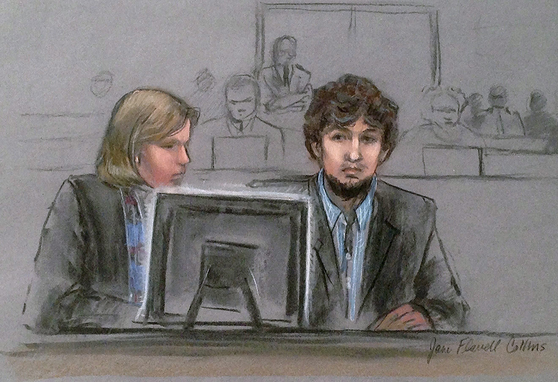 In this courtroom sketch, Dzhokhar Tsarnaev, right, and defense attorney Judy Clarke are depicted watching evidence displayed on a monitor during his federal death penalty trial.