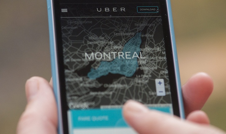 A woman browses an Uber website on her smartphone in Montreal, Monday, November 24, 2014.