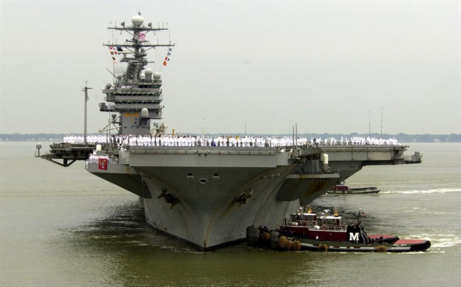 U.S. defence officials say U.S. Navy ships will begin accompanying U.S.-flagged commercial ships when they transit the Strait of Hormuz.