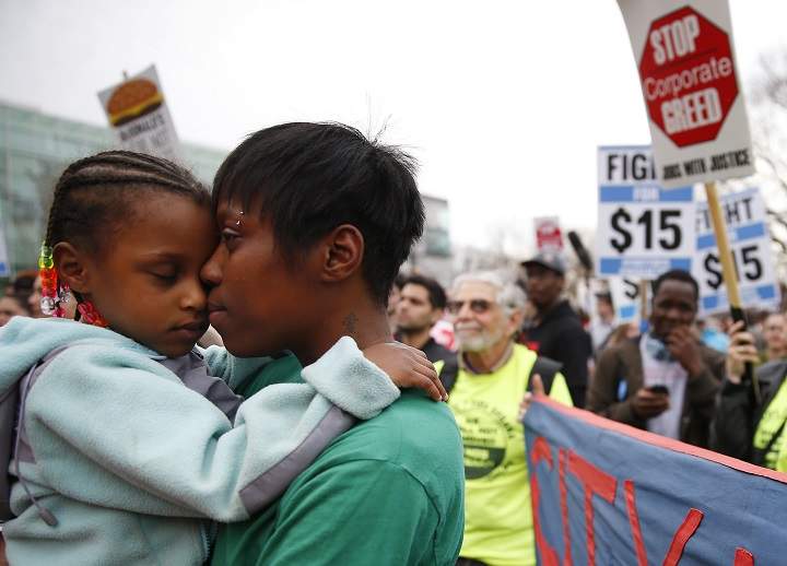 Latrese Williams of Dedham snuggled with her daughter, Desirae Shealey, 4, at a rally against income inequality in Boston on April 14, 2015.