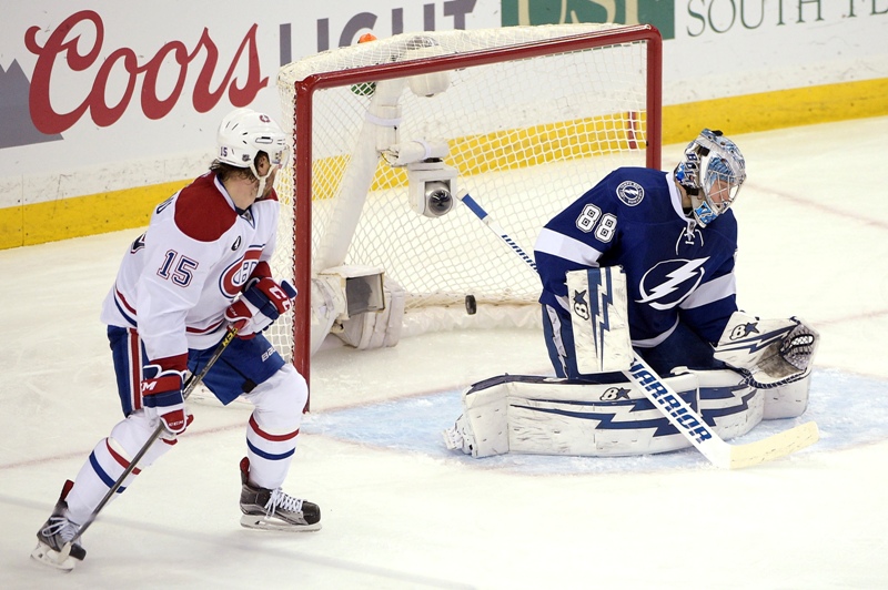 Montreal Canadiens right wing P.A. Parenteau, left, watches as a shot by defenseman Jeff Petry gets past Tampa Bay Lightning goalie Andrei Vasilevskiy,right, of Russia, during the second period of Game 4 of a second-round NHL Stanley Cup hockey playoff series in Tampa, Fla., Thursday, May 7, 2015.