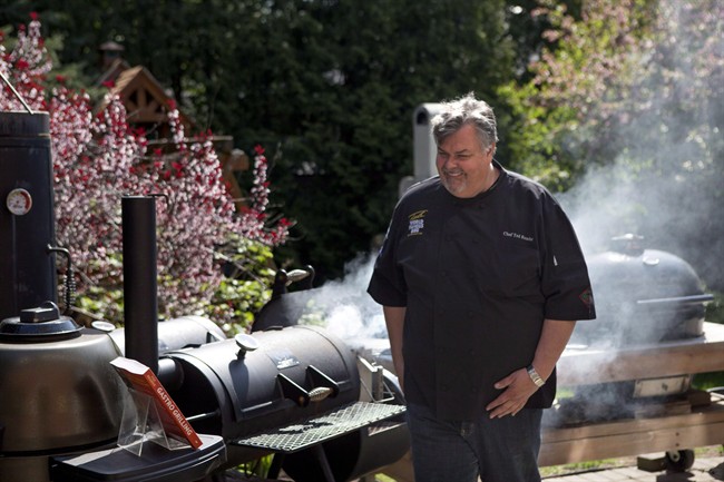 Ted Reader, author of the recent book "Gastro Grilling" fires up a charcoal grill in Toronto on Wednesday May 15, 2013.