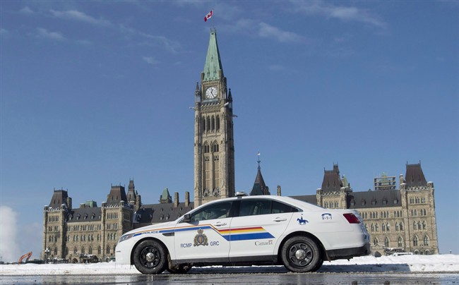 An RCMP police car sits outside the Parliament buildings on Parliament Hill in Ottawa on February 6, 2015. 