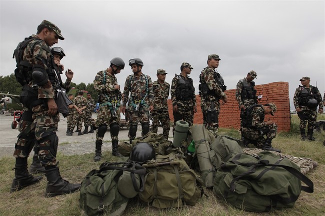 Nepalese army soldiers prepare to leave for a rescue mission to the site where the suspected wreckage of a U.S. Marine helicopter, that disappeared earlier this week while on a relief mission in the earthquake-hit Himalayan nation was spotted.