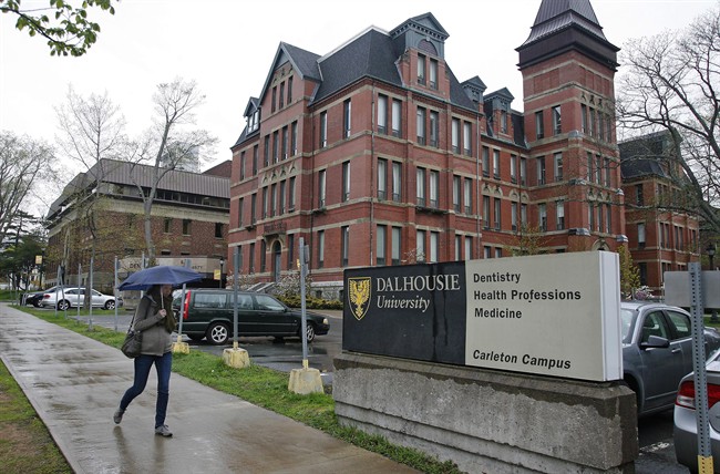 A pedestrian walks by the Dalhousie Dentistry Building in Halifax on Friday, May 22, 2015. A report into sexist online posts by dentistry students at Dalhousie University has found that a Facebook page at the centre of the scandal began as a bonding exercise, but turned offensive. Despite the report's findings, the university says the academic standards class committee determined the men are eligible to graduate as long as they satisfy their clinical requirements. 