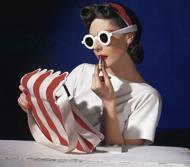 Model Muriel Maxwell putting on lipstick. American Vogue cover, 1 July 1939. Photograph: Conde Nast, Horst Estate