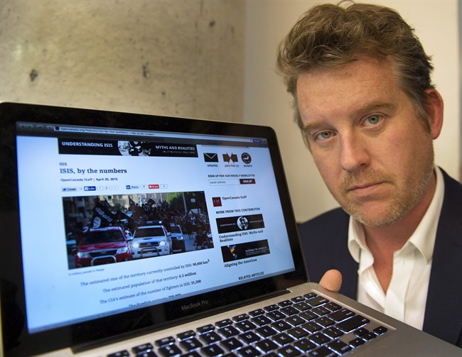 Kyle Matthews, with the Montreal Institute for Genocide and Human Rights Studies, shows some of the material used by jihadists on the internet, Friday, May 29, 2015 in Montreal. 