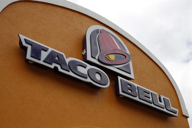 This Friday, May 23, 2014, file photo shows a sign at a Taco Bell in Mount Lebanon, Pa. Taco Bell and Pizza Hut say they're getting rid of artificial colors and flavors, making them the latest big food companies scrambling to distance themselves from ingredients people might find unappetizing.
