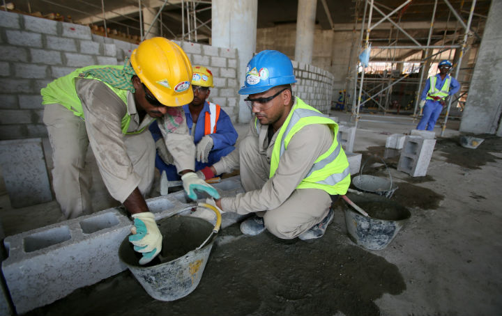 Migrant labourers work on a construction site on October 3, 2013 in Doha in Qatar. Qatar, the 2022 World Cup host is under fire over claims of using forced labour.