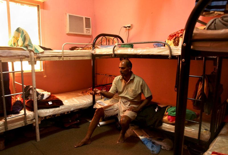  In this Sunday, May 3, 2015 file photo taken during a government organized media tour, Kuttamon Chembadnan Velayi from Kerala, India, speaks to journalists while sitting on his bed in a room he shares with seven other Indian laborers in Doha, Qatar. 