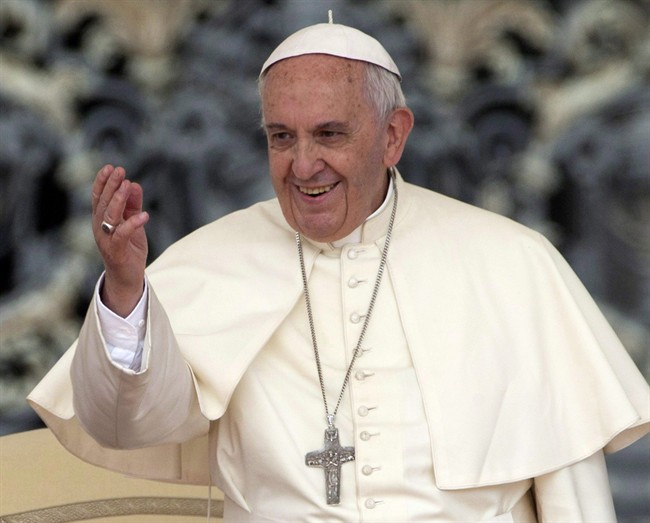 Pope Francis waves to faithful during his weekly general audience, in St. Peter's Square, at the Vatican on May 20, 2015. THE CANADIAN PRESS/AP, Andrew Medichini.