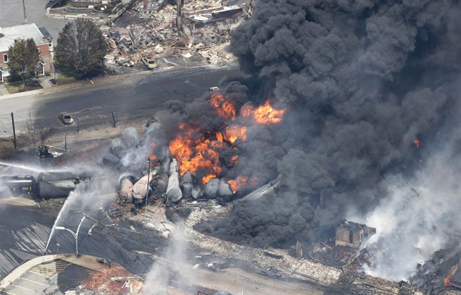 Smoke rises from railway cars that were carrying crude oil after derailing in downtown Lac-Mégantic, Que., on July 6, 2013. The railway at the centre of the disaster will not stand trial the Crown announced on Tuesday, April 3, 2018.