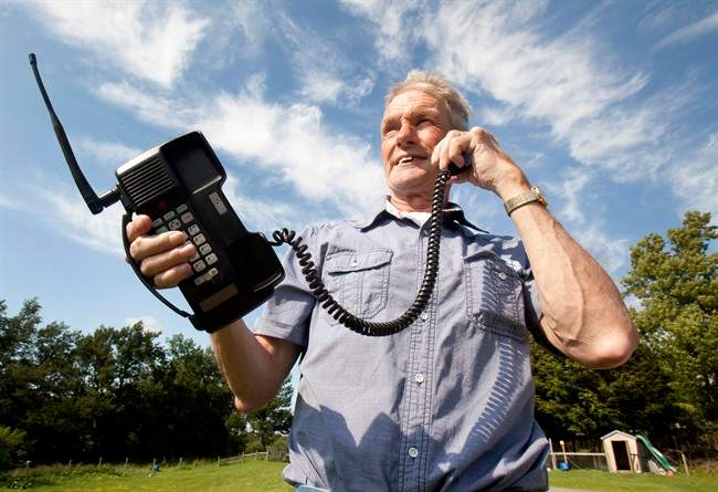 Victor Surerus poses for a photo at his farm in Roseneath, Ontario, on Wednesday, June 24, 2015 with the first cell phone in Canada. 
