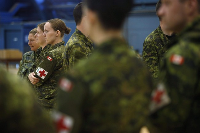 Soldiers returning from a medical mission in Sierra Leone wait for their medical assessments at the Ottawa International Airport on March 6, 2015.
