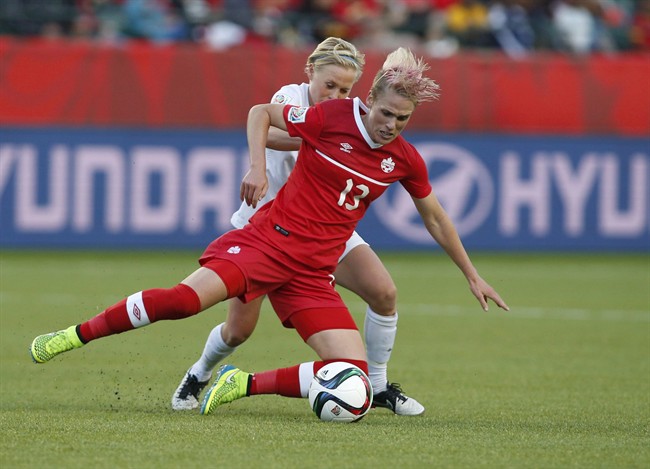 Canada’s Sophie Schmidt and New Zealand’s Betsy Hassett battle for the ball during second half FIFA Women’s World Cup soccer action in Edmonton, Alta., Thursday, June11, 2015.