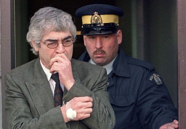 Larry Fisher is led out of the Yorkton, Saskatchewan court house, on Saturday, November 20, 1999.