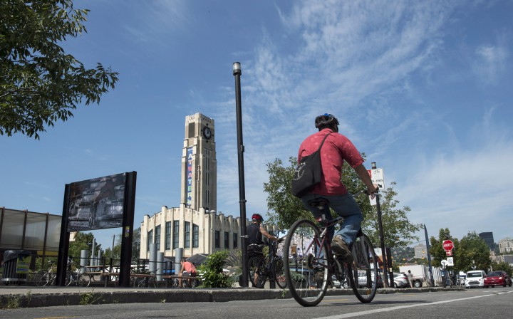 A cyclist rides his bike past the Atwater Market in Montreal.