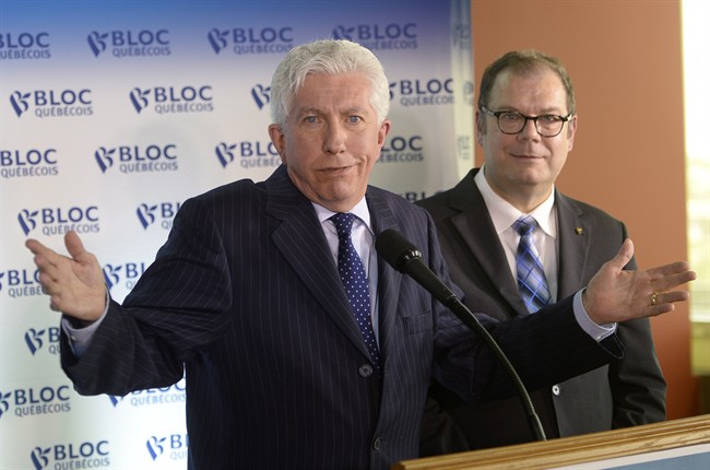 Bloc Quebecois Leader Gilles Duceppe gestures at a news conference in Montreal on Wednesday, June 10, 2015 as party president Mario Beaulieu looks on. 