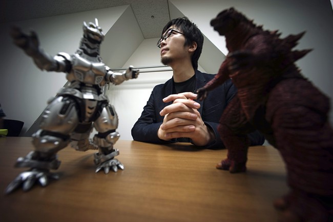 In this May 20, 2015 photo, Shunsuke Fujita, Godzilla video game's producer of Bandai Namco Entertainment, speaks on new Godzilla game for the Sony Corp. PlayStation 4 home machine in Tokyo. 