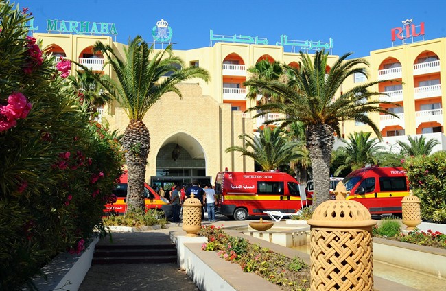Injured people are treated near the area where an attack took place in Sousse, Tunisia, Friday June 26, 2015.