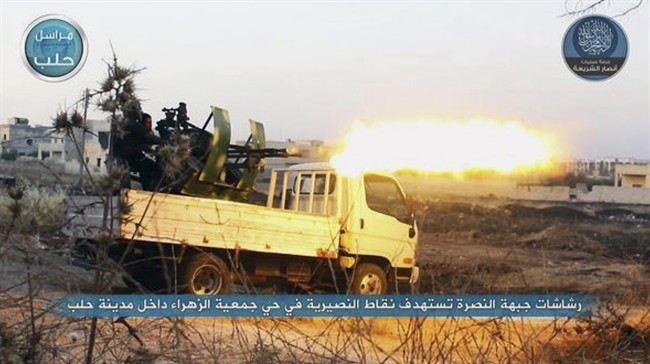 In this image posted on the Twitter page of Syria's al-Qaida-linked Nusra Front on early Tuesday, July 7, 2015, a fighter from the Nusra Front fires a weapon during clashes against the Syrian government forces at the western Zahra neighborhood in Aleppo city, Syria. 