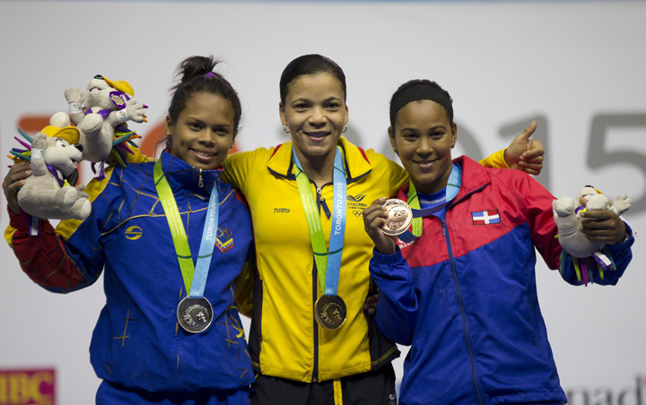 Medal winners in the women's 53kg weightlifting pose together on the podium at the Pan Am Games in Oshawa, Ontario, Sunday, July 12, 2015. From left are silver medal winner Genesis Rodriguez Gomez of Venezuela, gold medal winner Rusmeris Villar Barboza of Colombia, and bronze medal winner Yafreysi Silvestre Velgar of Dominican Republic.