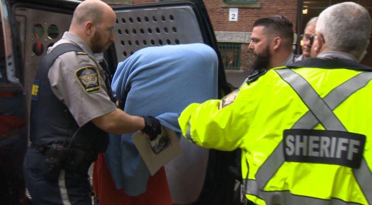 Jimmy Melvin Jr. covers his face as he is led into court in 2015.