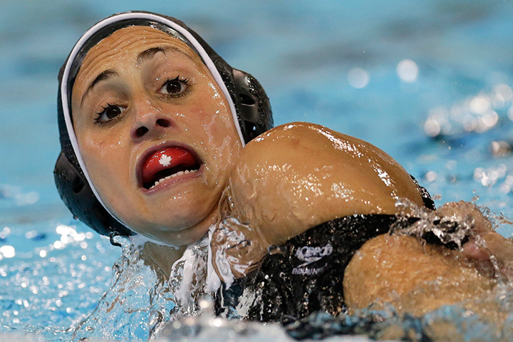 Canada’s Joelle Bekhazi reacts as she is grabbed by Venezuela’s Nibley Pina Tovar during a water polo match at the Pan Am Games in Markham, Ontario, Wednesday, July 8, 2015.