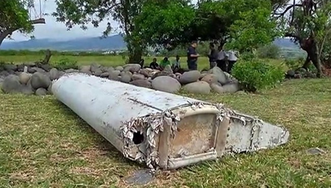 This image taken from video, shows a piece of debris from a plane, Wednesday, July 29, 2015, in Saint-Andre, Reunion. Air safety investigators, one of them a Boeing investigator, have identified the component as a "flaperon" from the trailing edge of a Boeing 777 wing, a U.S. official said. Flight 370, which disappeared March 8, 2014, with 239 people on board, is the only 777 known to be missing.