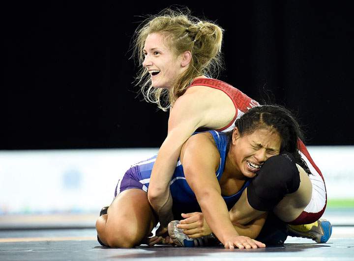 Gene Morrison, top, of Canada moments before time runs out to defeat Thalia Mallqui of Peru in the women's freestyle 48kg final during the Pan American Games in Toronto on Thursday, July 16, 2015. Morrison won gold.